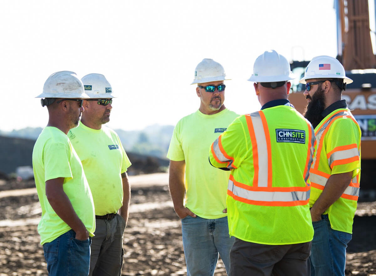 Team of five CH+N Site workers regrouping on a project