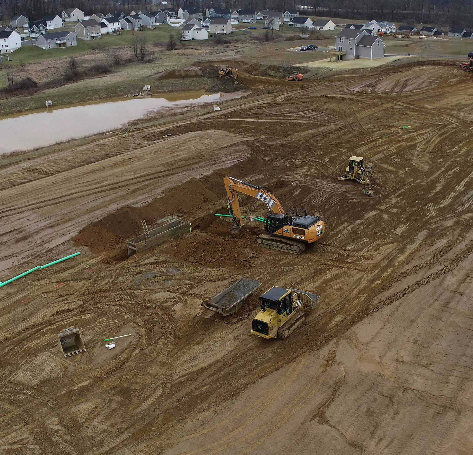 CH+N equipment excavating level ground for a new Creekside homes development